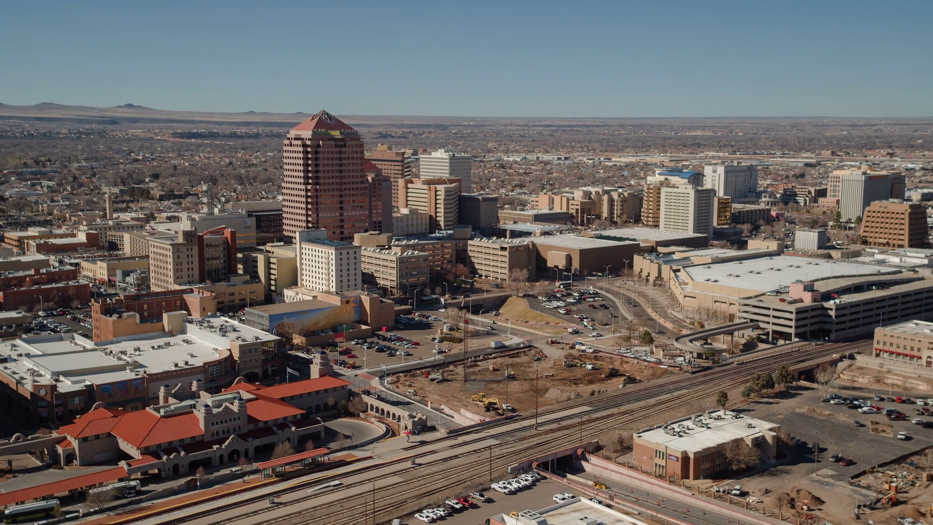 Aerial view of the Albuquerque New Mexico downtown skyline with the high desert and mountains beyond