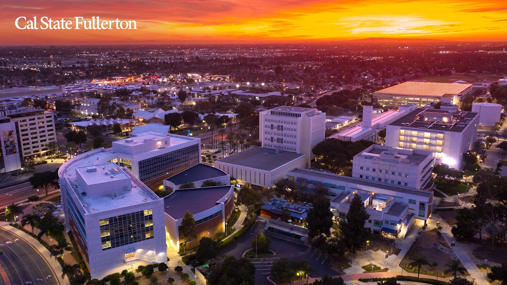 Aerial view of the Cal State Fullerton campus at sunset in north Orange County under a dry inland sky
