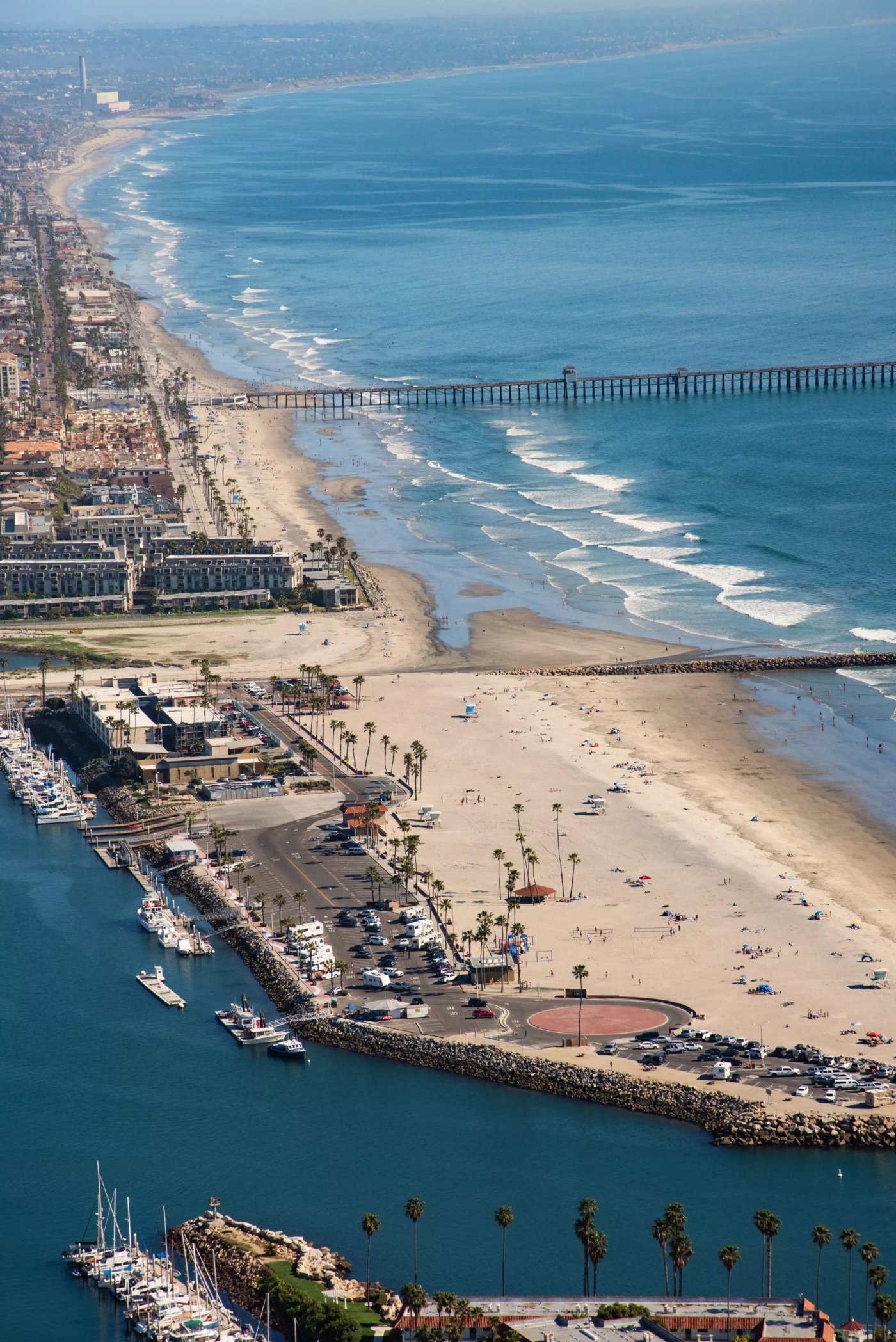 Aerial view of Oceanside California coast, pier and harbor served across North County by mobile water stations