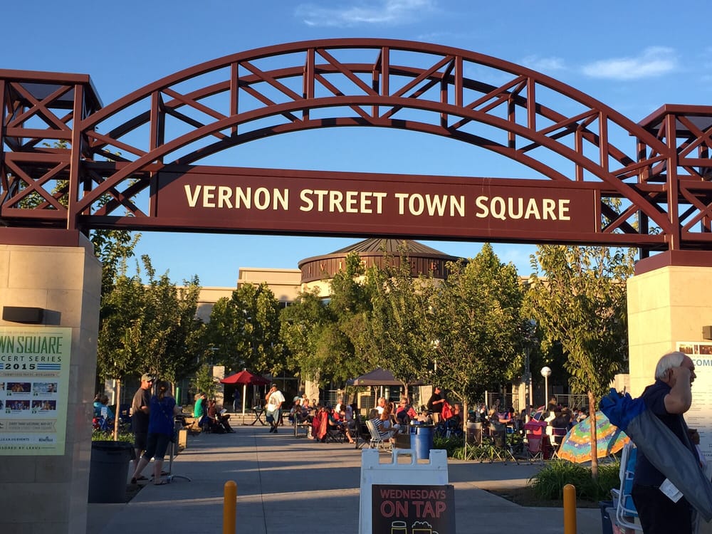 The Vernon Street Town Square arch in downtown Roseville with an evening event crowd in Placer County
