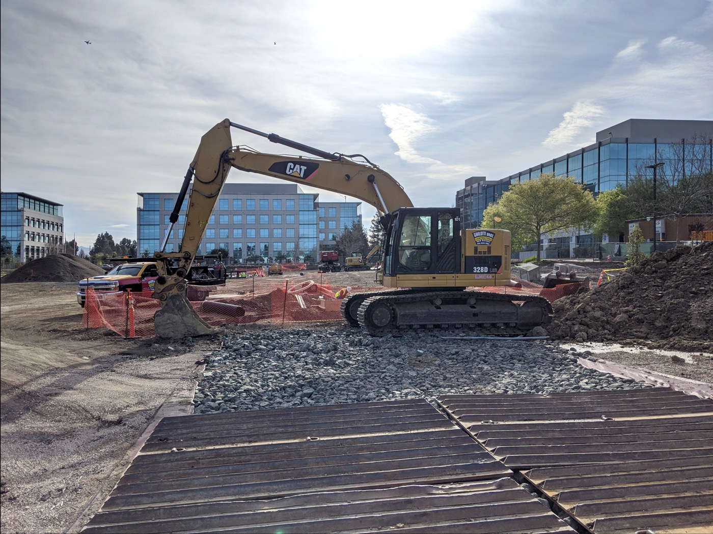 Sunnyvale construction site with an excavator and Silicon Valley office buildings behind, the kind of build a mobile water station serves