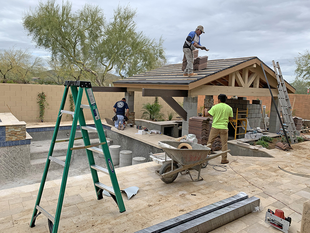 Outdoor construction crew building in the Gilbert desert sun with on-site cold water nearby