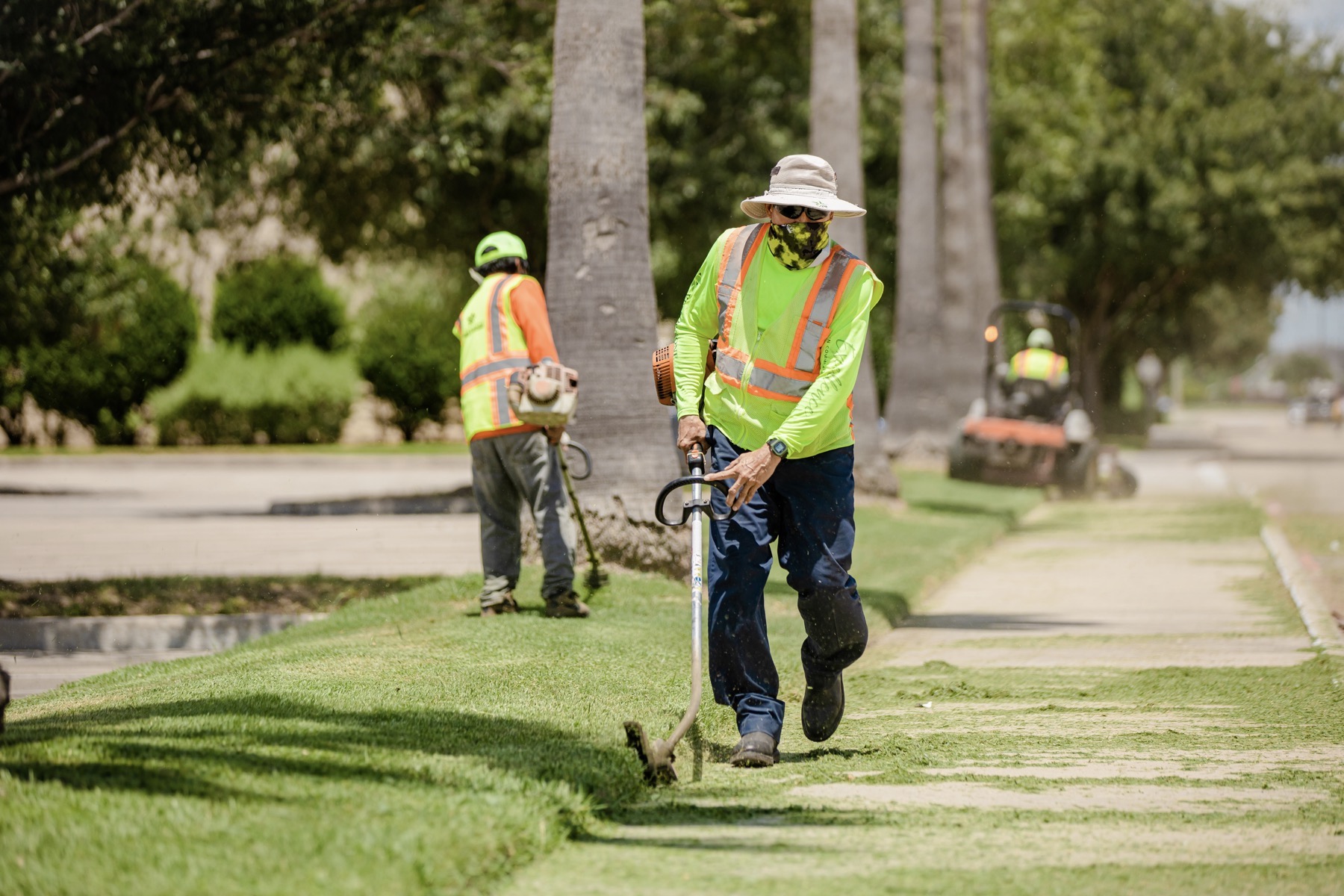 Outdoor landscaping crew working through West Valley heat near Glendale with cold water close at hand