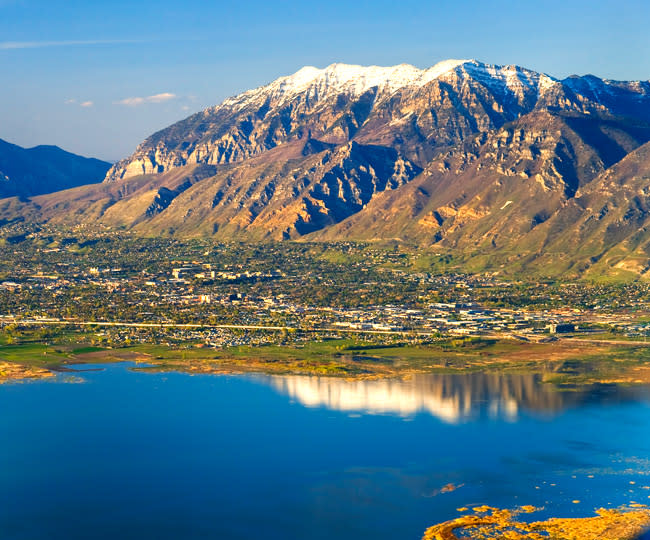 Aerial view of the Orem and Utah Valley metro below Mount Timpanogos and Utah Lake along the Wasatch Front