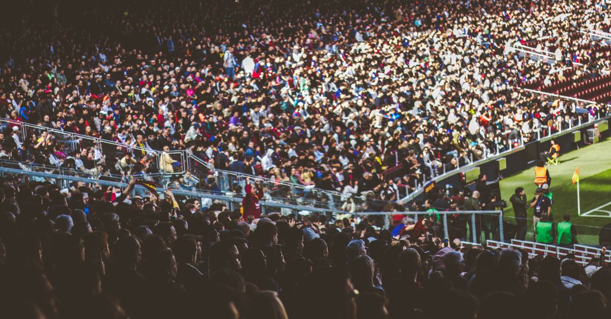Large outdoor stadium crowd on a warm Sandy, Utah evening served by mobile drinking water stations