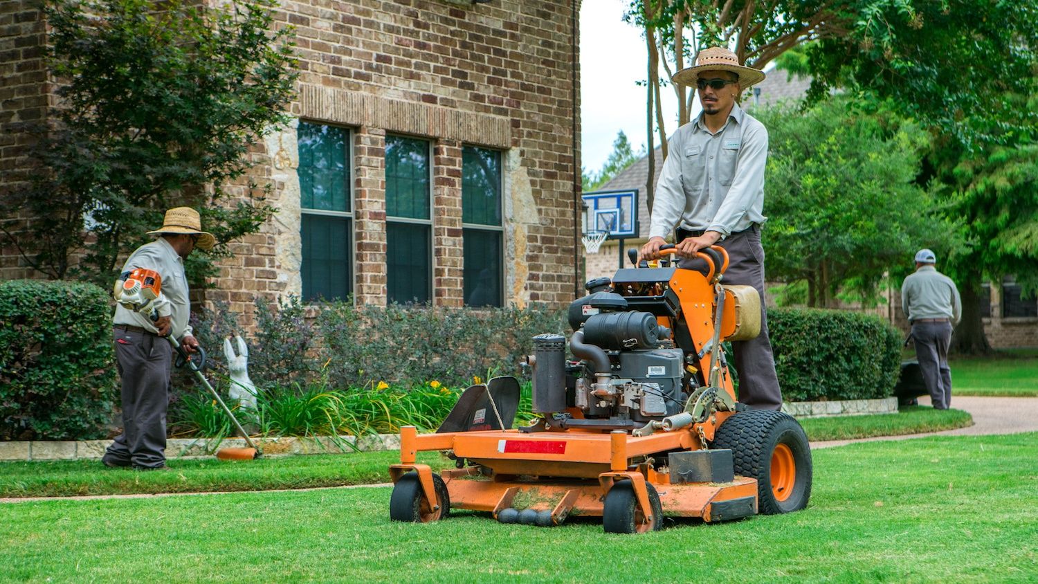 Landscaping and grounds crew working in the heat, outdoor labor served by a Scottsdale mobile drinking-water station