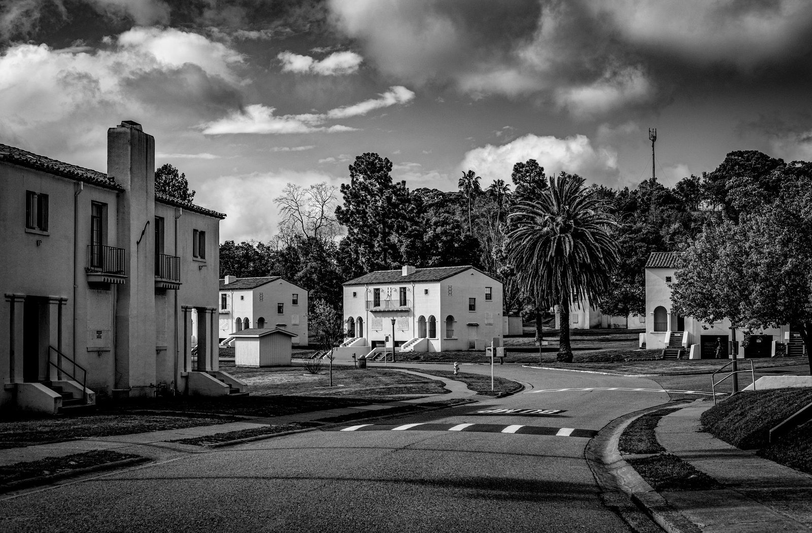 A quiet residential street with Spanish-style homes and palm trees